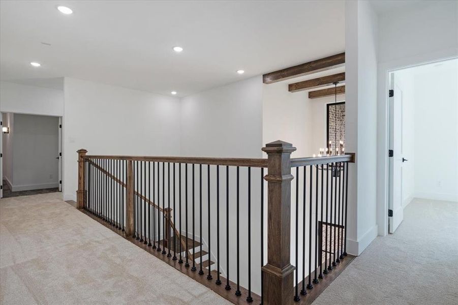 Hall featuring beamed ceiling and carpet flooring