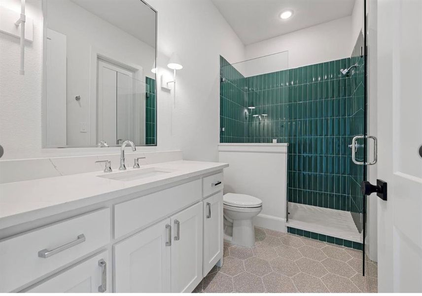 Bathroom with tile patterned floors, toilet, an enclosed shower, and vanity