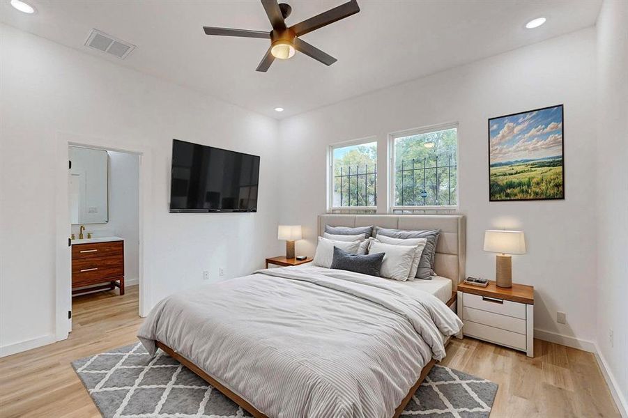 Bedroom featuring ceiling fan and light hardwood / wood-style flooring