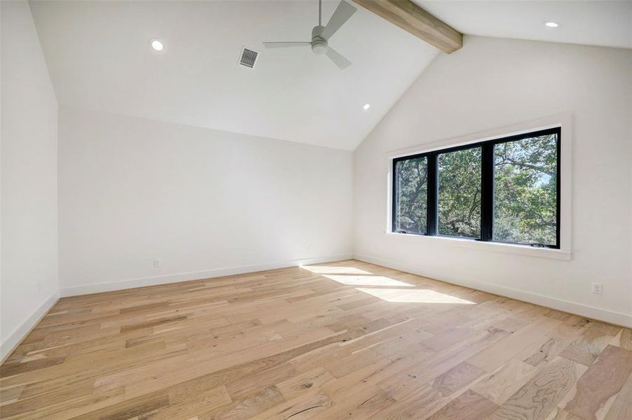 SAMPLE - Primary bedroom has large south facing windows with tree top views of magnificent oaks, The bed soaring beamed cathedral ceiling, ceiling fan, engineered wood floors and is on its own auto tampered zone of air and heat.