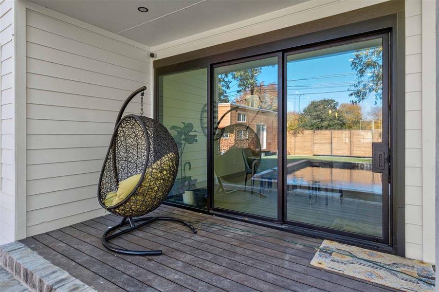 The covered patio provides shade and an ideal spot for outdoor dining and lounging.