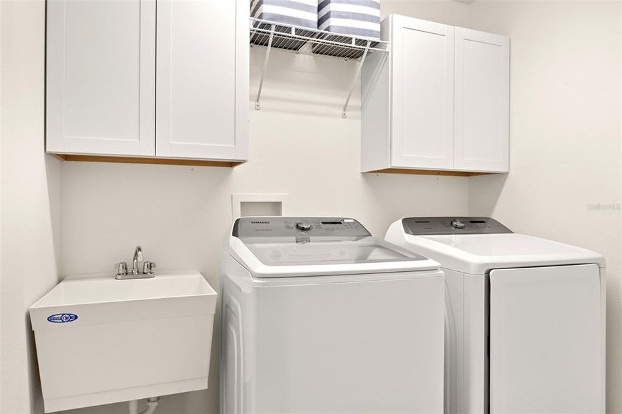 Nice Laundry with set sink, and added cabinets.