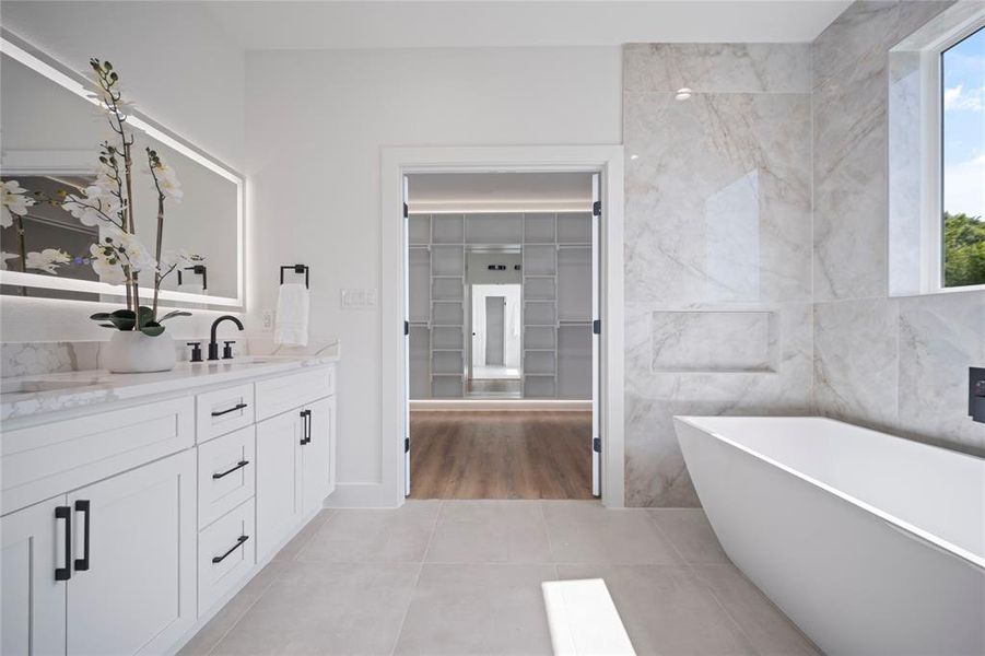 Bathroom featuring tile walls, tile patterned floors, and vanity