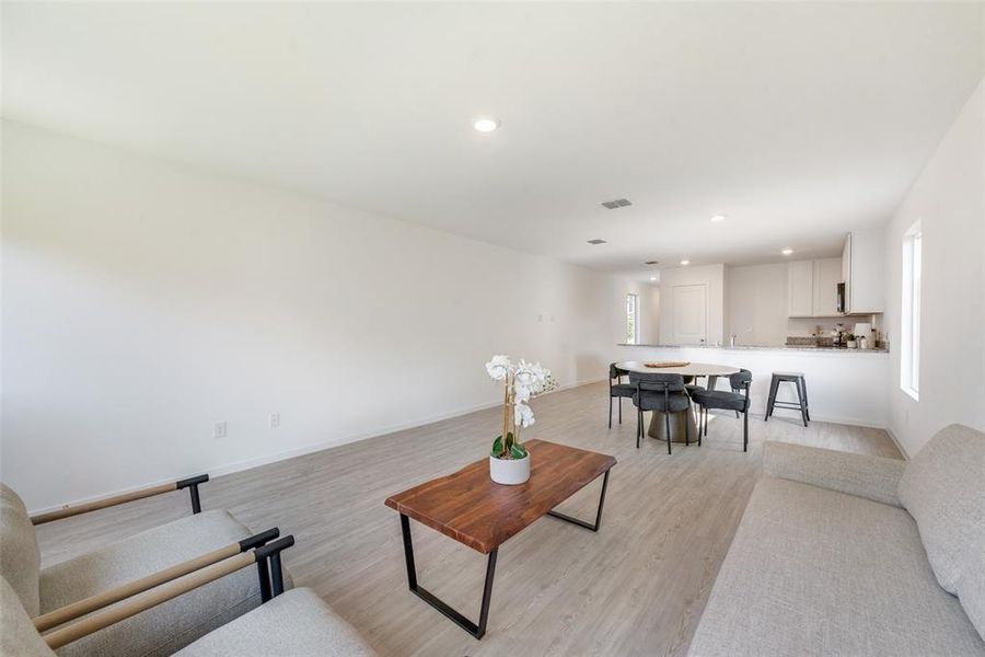 Living room with light hardwood / wood-style flooring