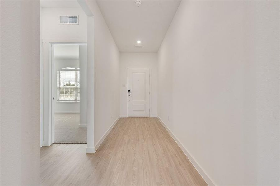 Hall featuring light hardwood / wood-style flooring