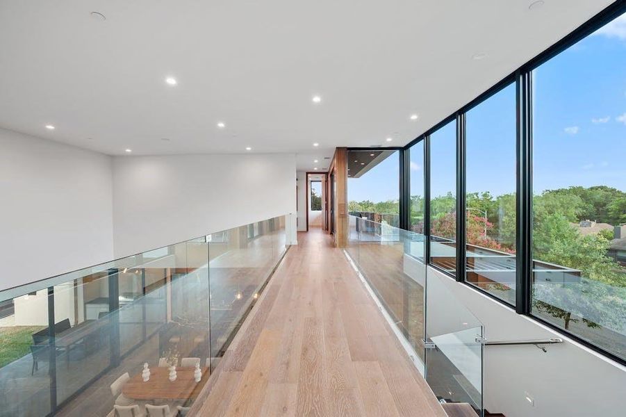 The impressive catwalk is a striking architectural element that adds a sense of grandeur and openness to the home. Elevated and elegantly designed, it spans across the upper level, offering stunning views of the living spaces below.
