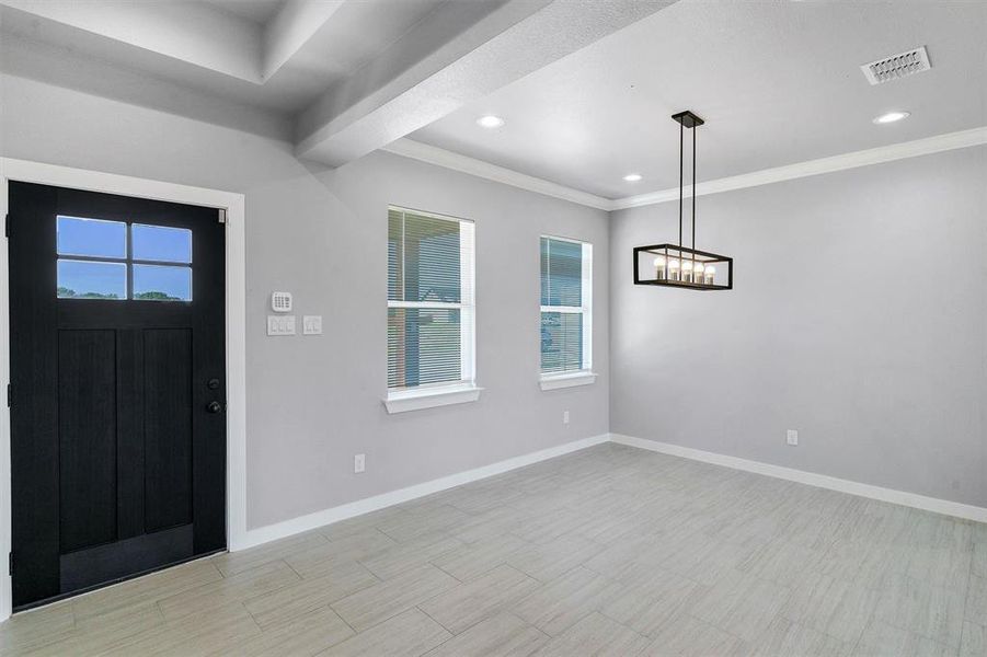 Foyer featuring ornamental molding and a healthy amount of sunlight