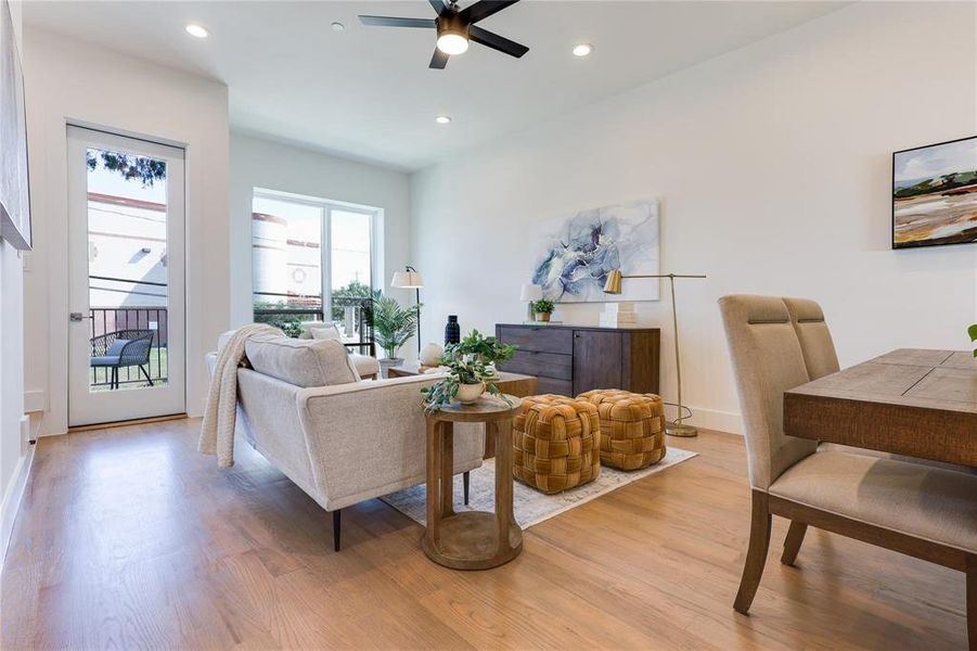 Living room featuring light hardwood / wood-style floors and ceiling fan