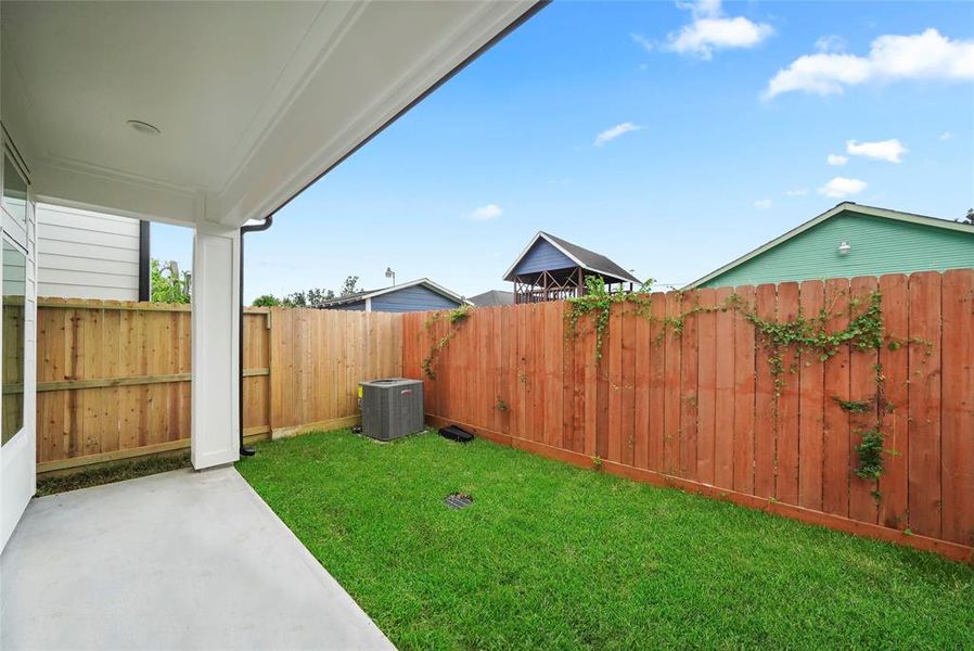 Inviting covered patio with a spacious backyard—perfect for barbecues and gatherings.