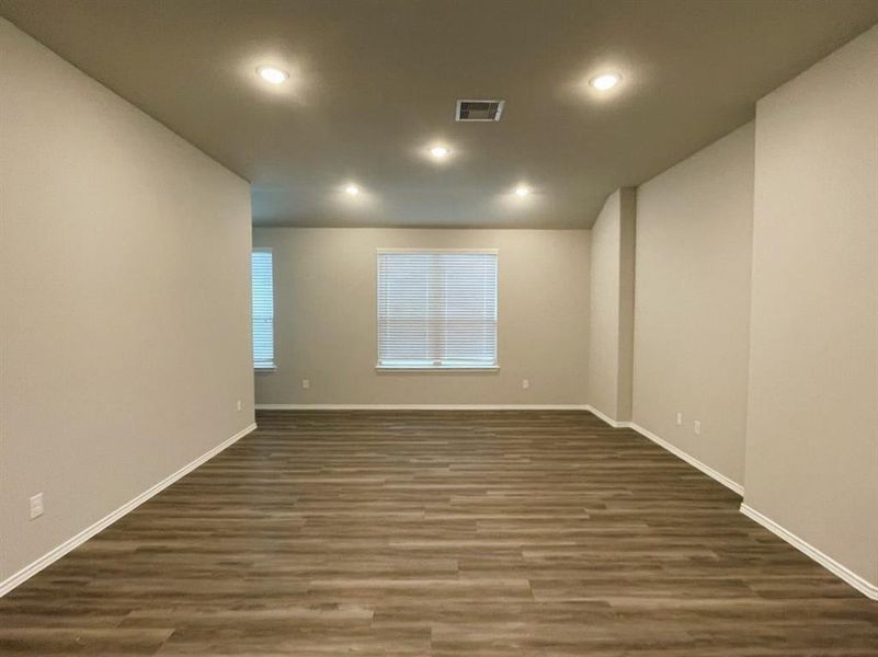 Another view of your living room featuring vaulted ceilings & entertainment niche!