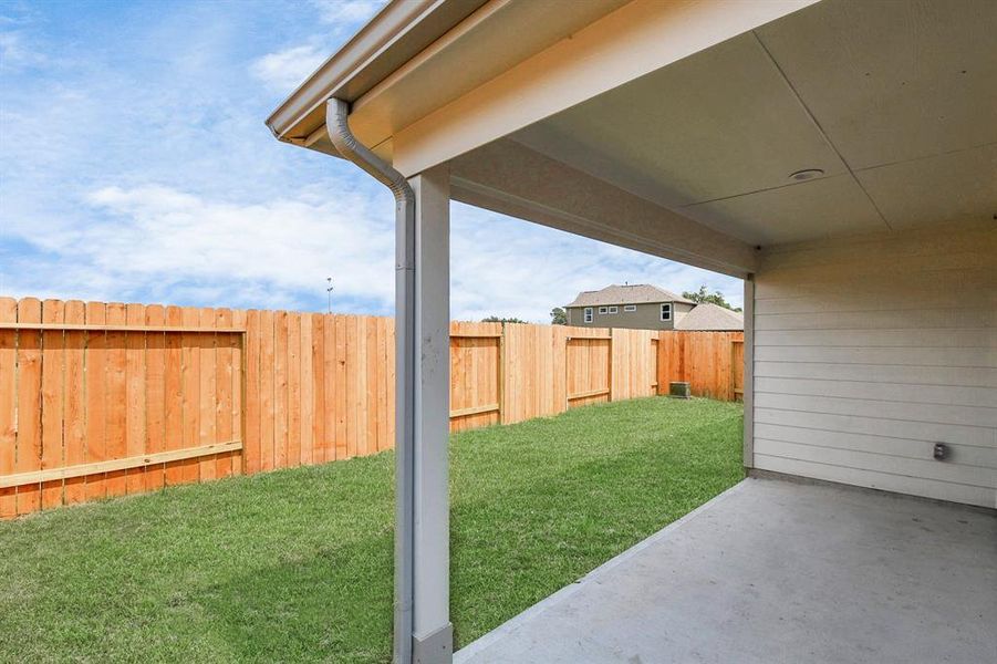 Discover the charm of this spacious backyard featuring a delightful covered patio.