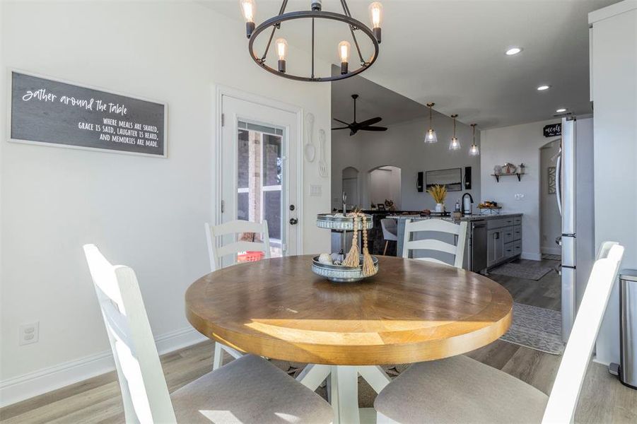 Dining room featuring notable chandelier and light hardwood / wood-style floors