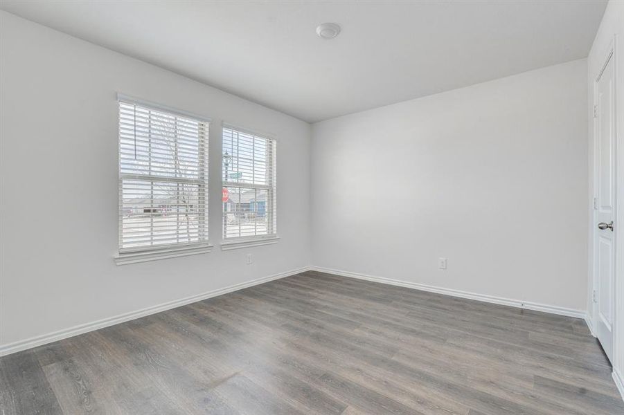 Unfurnished room with dark wood-type flooring