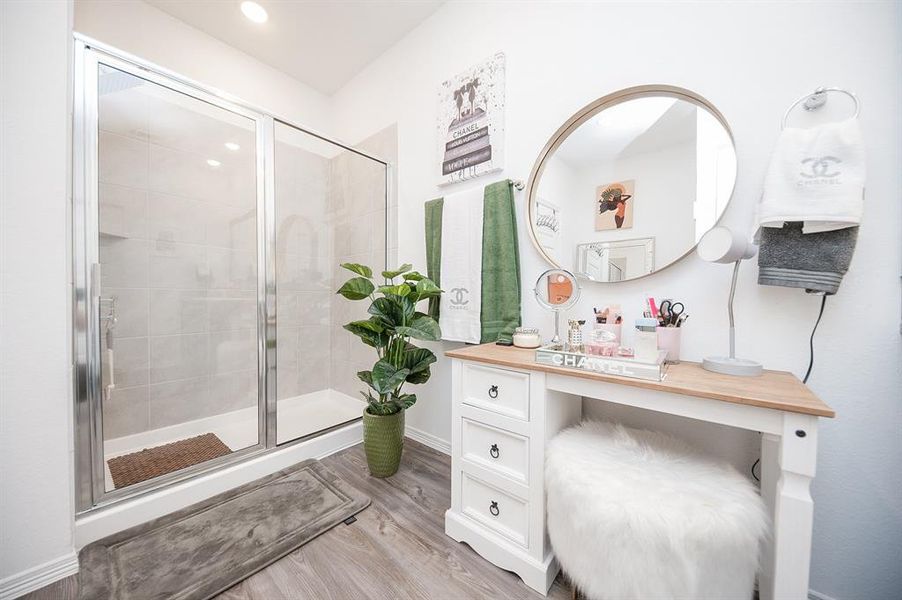 The room is so large, the seller has even carved out a little space for a make-up vanity.  The tiled shower is anchored along the back wall.