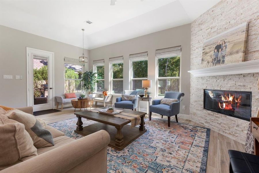 Gorgeous brick fireplace with mantel creates an eye-popping statement piece to the grand living room.