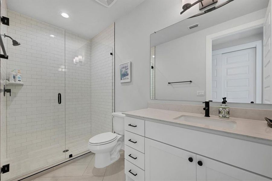 Guest bath on the main floor with a single vanity and walk-in shower