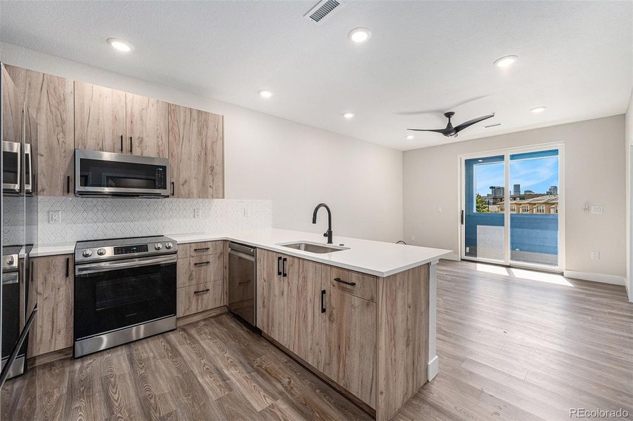 From kitchen to living room to outside balcony, downtown view.