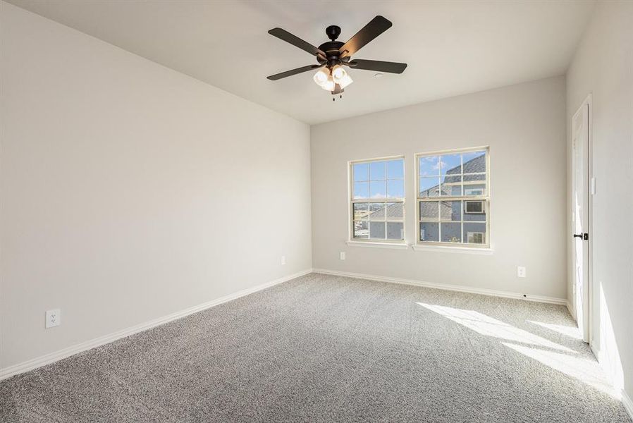 Unfurnished room featuring carpet flooring and ceiling fan