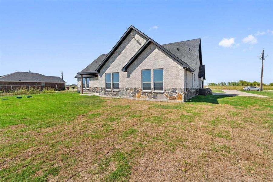 Rear view of house featuring a yard