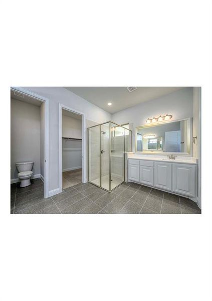 Bathroom featuring vanity, tile patterned floors, and an enclosed shower