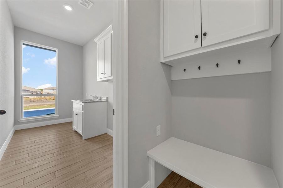 Mudroom featuring light hardwood / wood-style flooring and a wealth of natural light