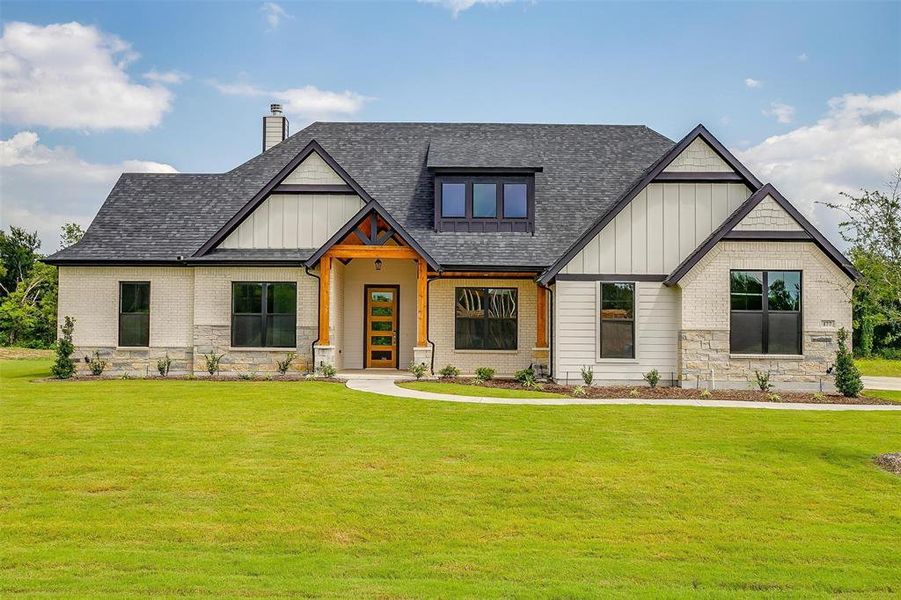 Craftsman-style home with a front lawn