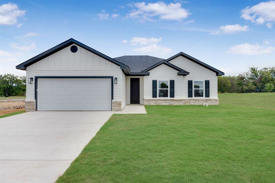 Ranch-style home with a garage and a front yard