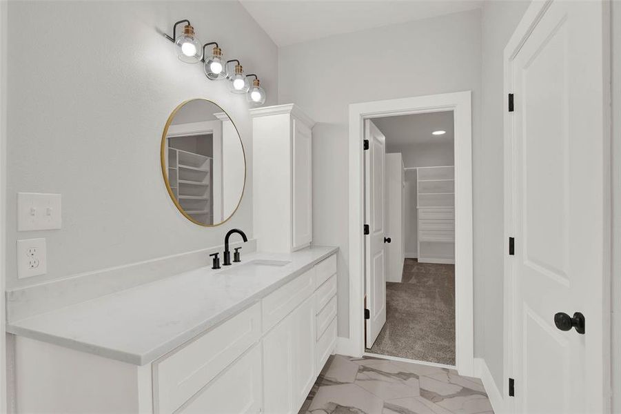Separate vanities and linen towers on both