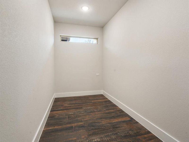 Empty room featuring dark wood-type flooring