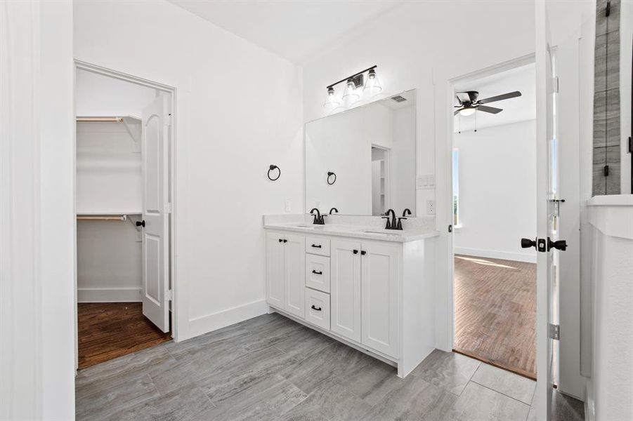 Bathroom featuring vanity, ceiling fan, and hardwood / wood-style flooring