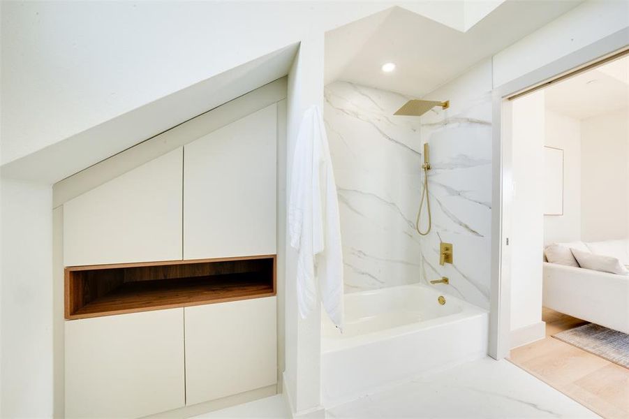 Bathroom with tiled shower / bath combo and hardwood / wood-style floors