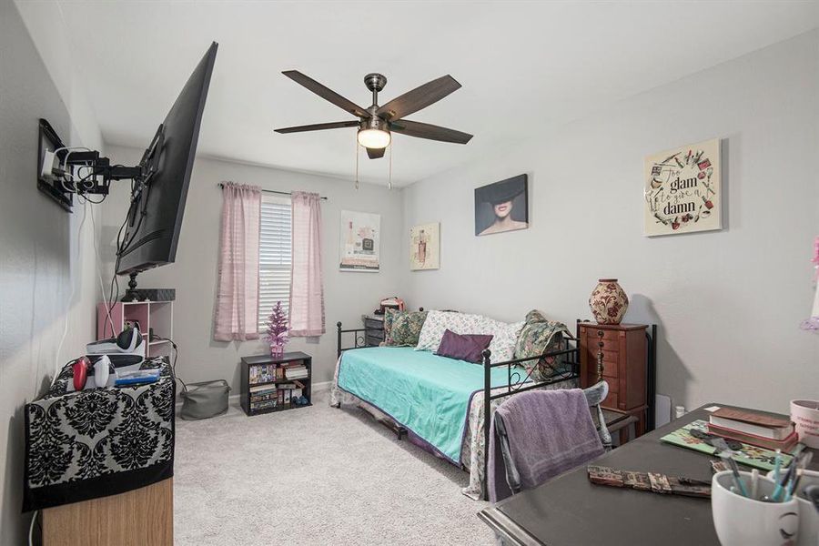 Bedroom with ceiling fan and carpet floors