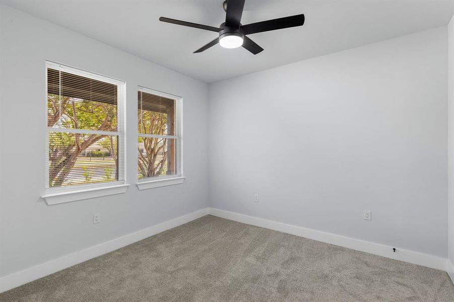 Unfurnished room with ceiling fan and light colored carpet