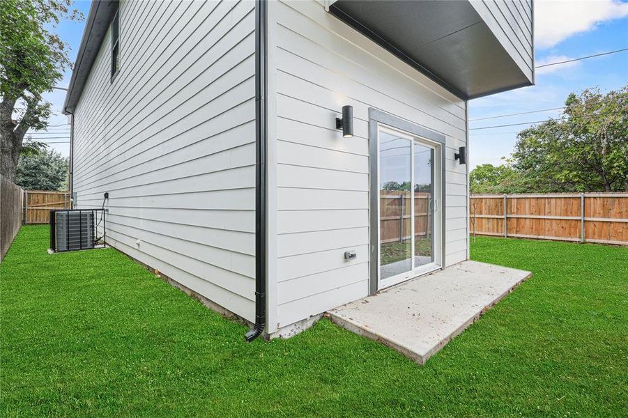 View of home's exterior with central AC unit and a lawn