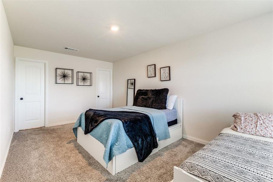 Bedroom with light colored carpet