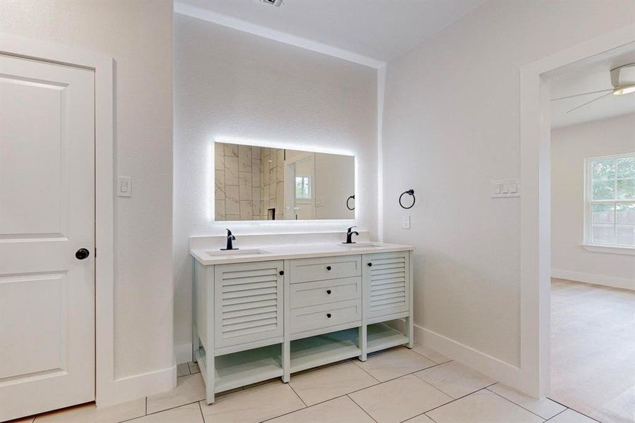 Bathroom with tile flooring, vanity, and ceiling fan