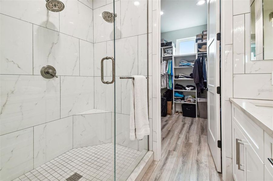 Dual shower heads in primary bathroom shower.