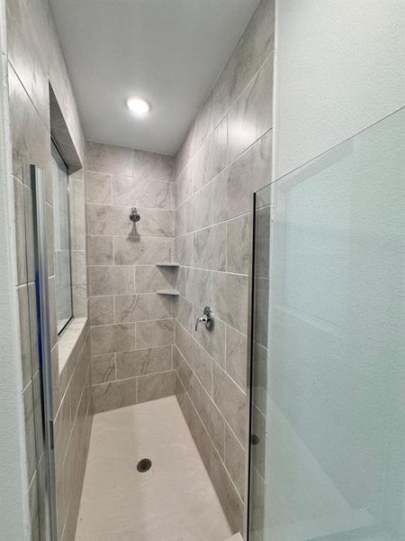 Bathroom featuring a tile shower