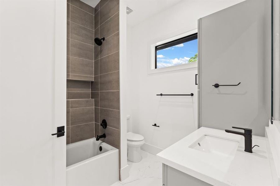 Step into the luxurious secondary bathroom, where a lavish shower/tub combo awaits, promising moments of relaxation and indulgence.