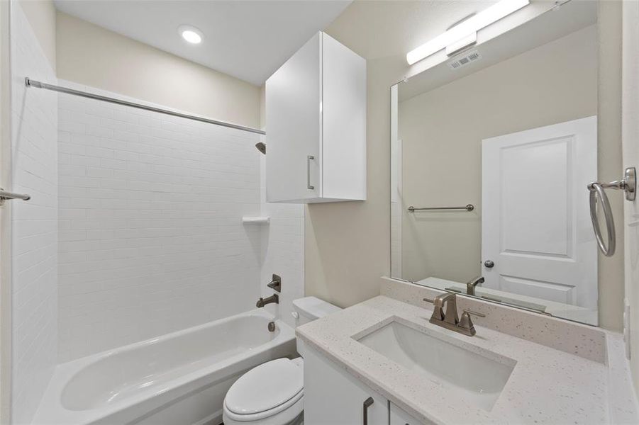 Full bathroom featuring vanity, shower / bathing tub combination, and toilet