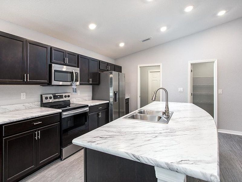 Enjoy your spacious kitchen with luxurious finishes and lots of storage - Photo showcases a home with similar finishes. Colors and design options in actual home for sale may differ.