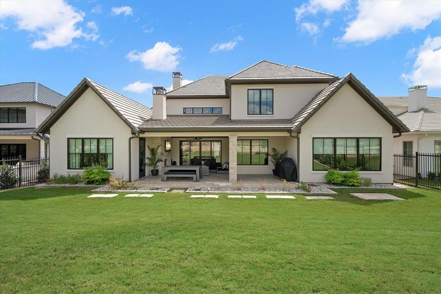 Rear view of property with a lawn, an outdoor hangout area, and a patio