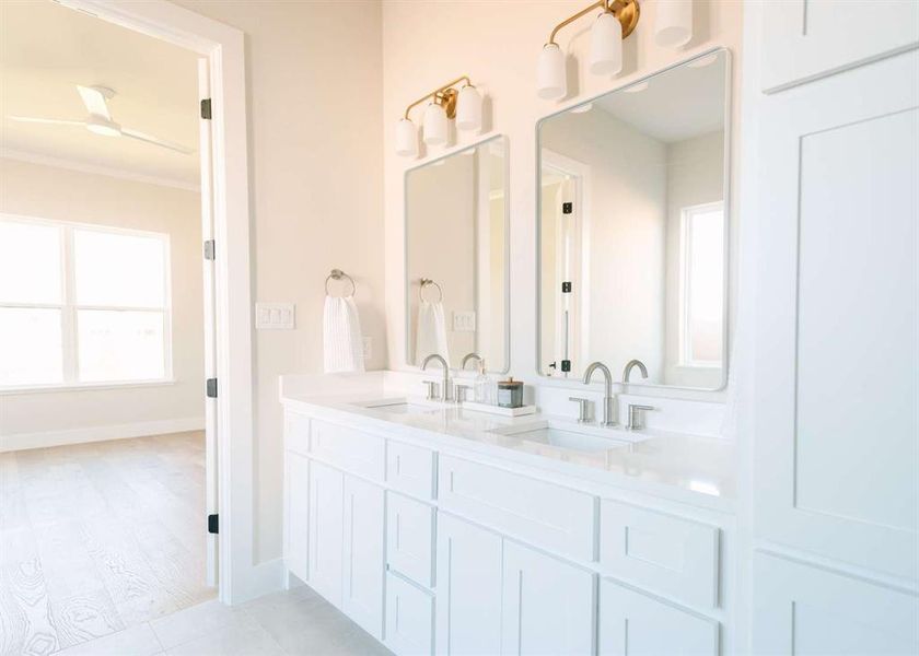 Bathroom with ornamental molding, vanity, and hardwood / wood-style flooring