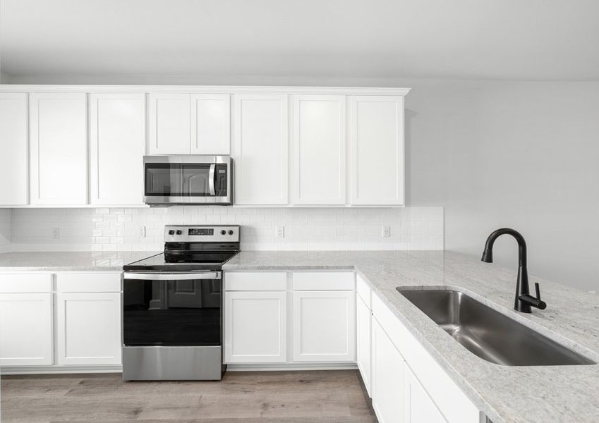 The kitchen of the Driftwood has beautiful white-wood cabinetry.