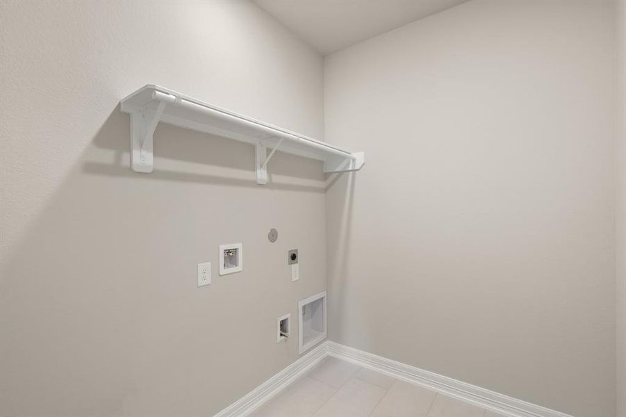 The laundry room layout is carefully planned for optimal workflow with designated areas for washing, drying, and storing.