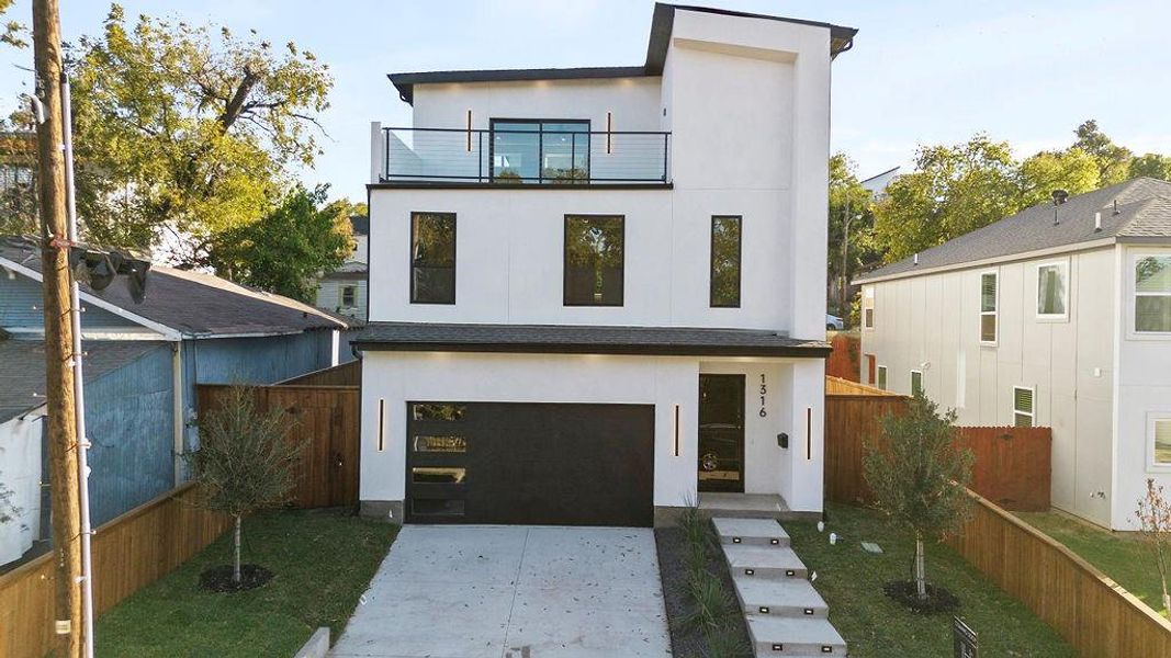 Modern home with a balcony and a garage