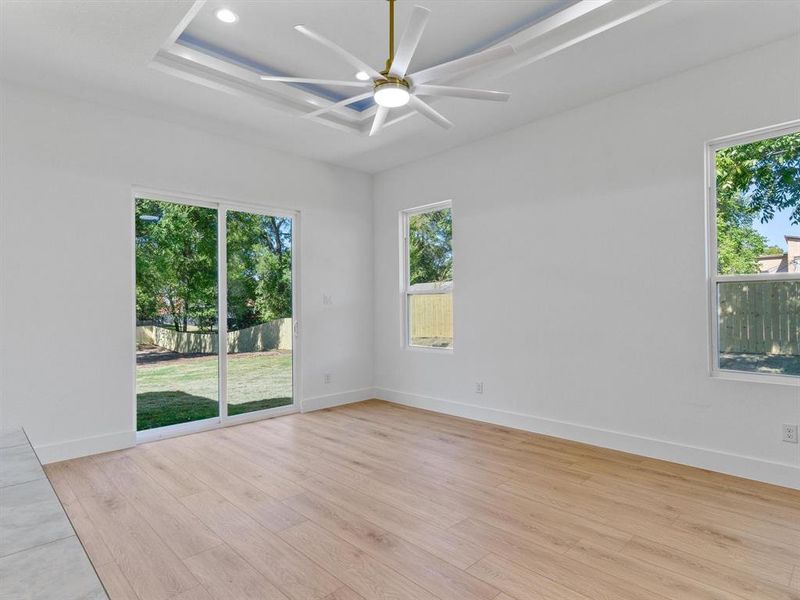 Empty room with light hardwood / wood-style flooring and ceiling fan