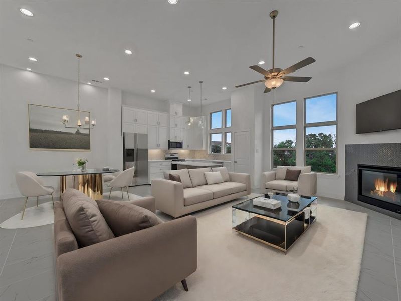 Living room with a towering ceiling, light tile floors, and ceiling fan with notable chandelier