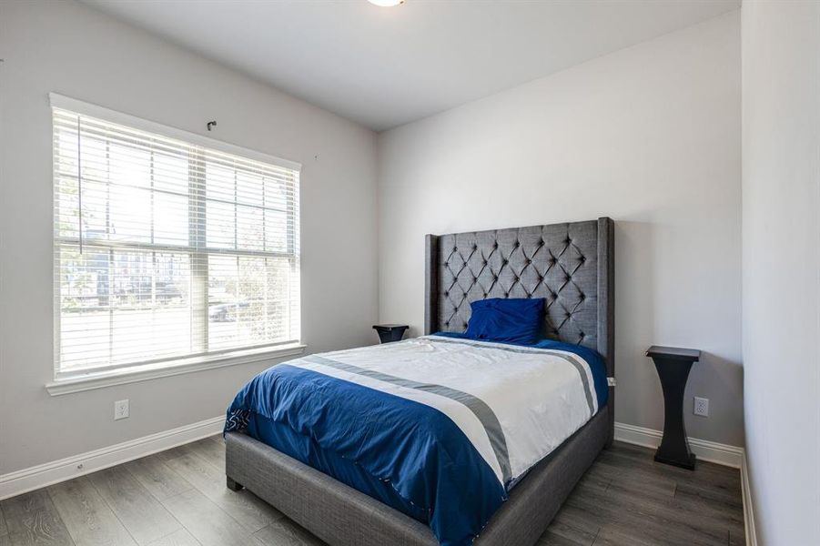 Bedroom featuring dark wood-type flooring