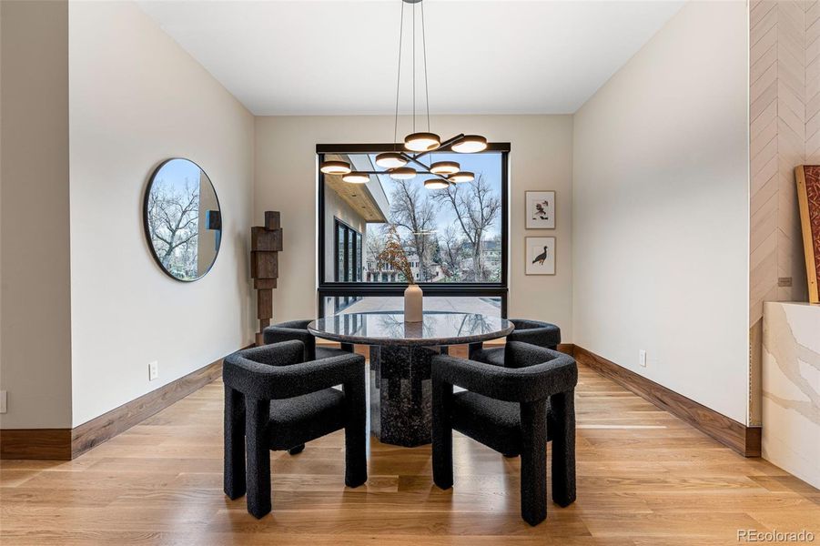 Eat-in kitchen breakfast area with large south-facing window with views of the backyard and beyond. Sonneman 9 light Light Ring Chandelier.